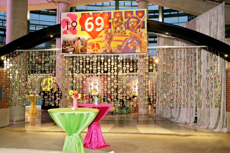 Graphic design and decor for the 1960s party at Ford Fie.d