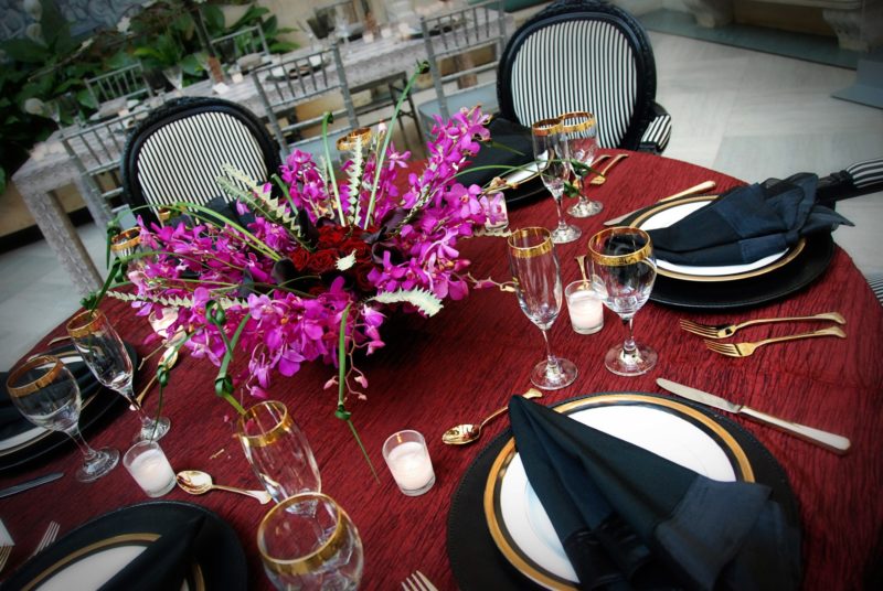 Dinnerware and banquet table with red tablecloth for event at Detroit Institute of Art