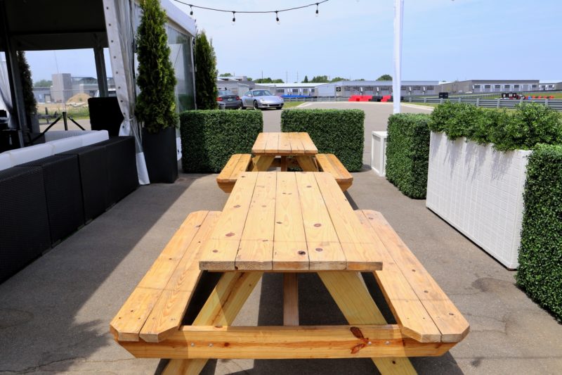 Wooden picnic tables for an outdoor event.