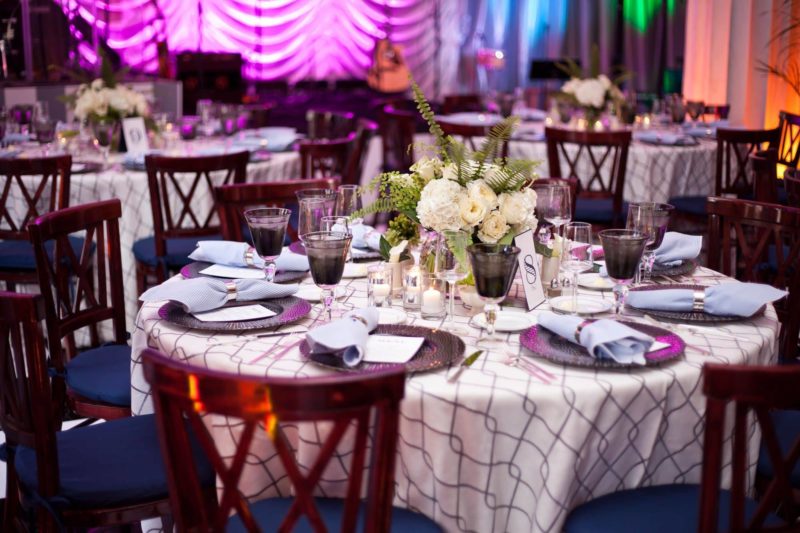 Round table with dinnerware and floral centerpiece for event in Michigan