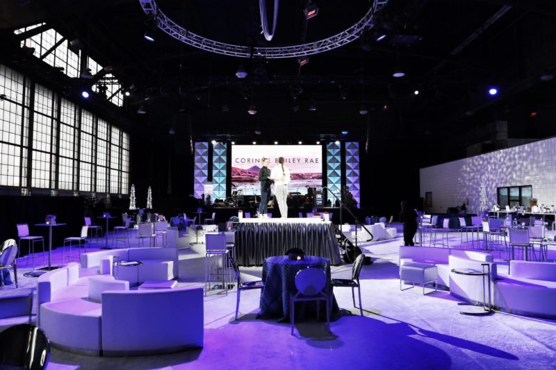 Floorplan featuring a stage, video screen, couches and tables for a corporate event.